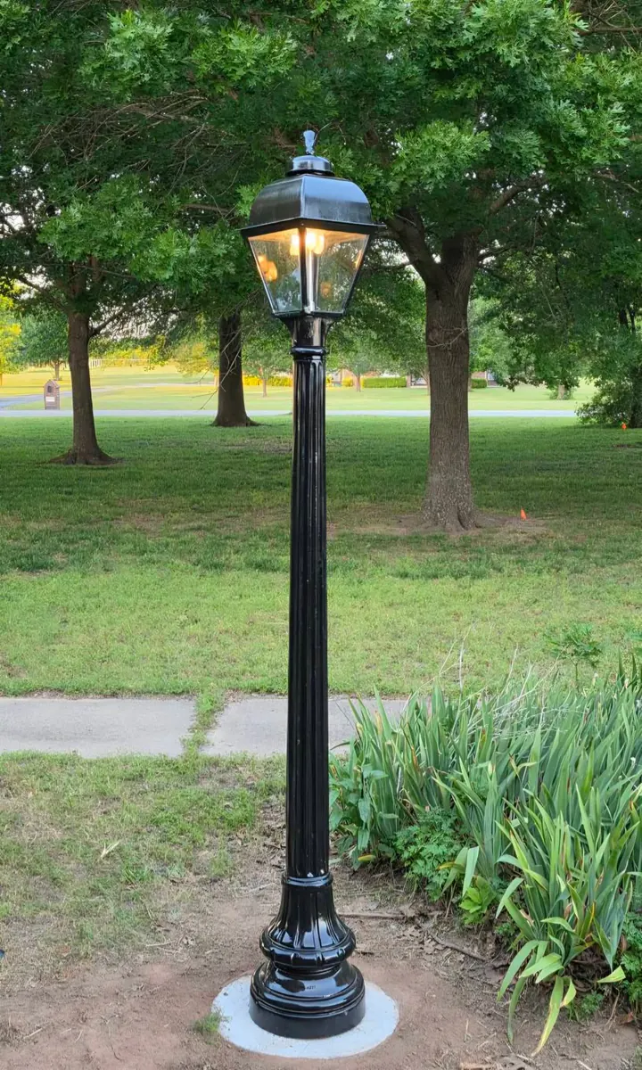 Natural gas post lamp installed in a front yard