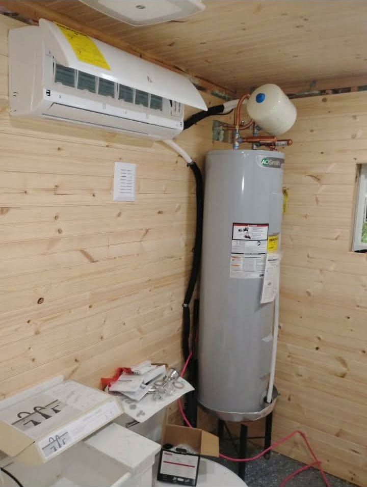 Ductless mini-split head mounted on an interior wall